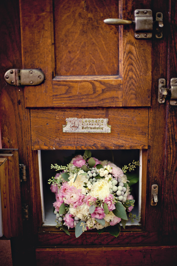 pink and ivory bouquet resting on a door - wedding photo by top Atlanta based wedding photographers Scobey Photography